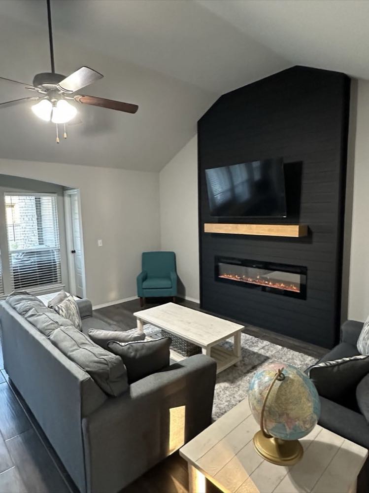 Interior remodel with a black shiplap fireplace feature wall and mounted TV