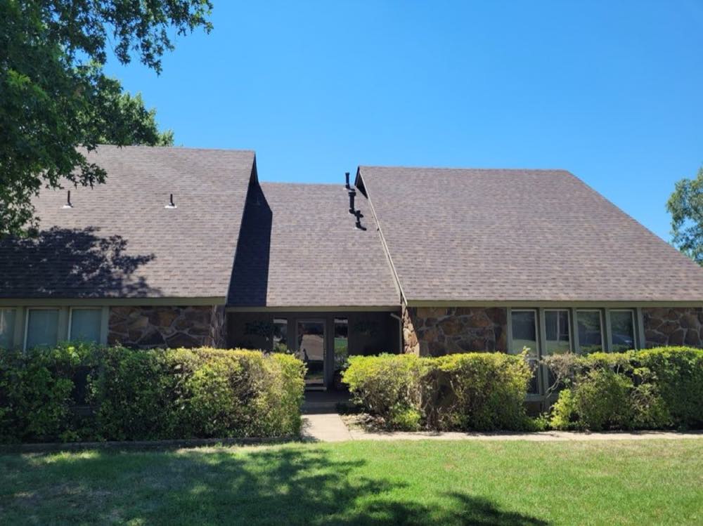 Finished brown shingle roof on a stone-front ranch home in Tulsa